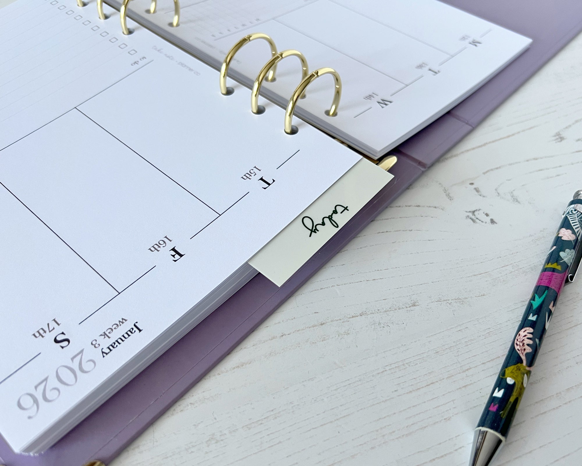 Calendar planner with a pen on a light surface