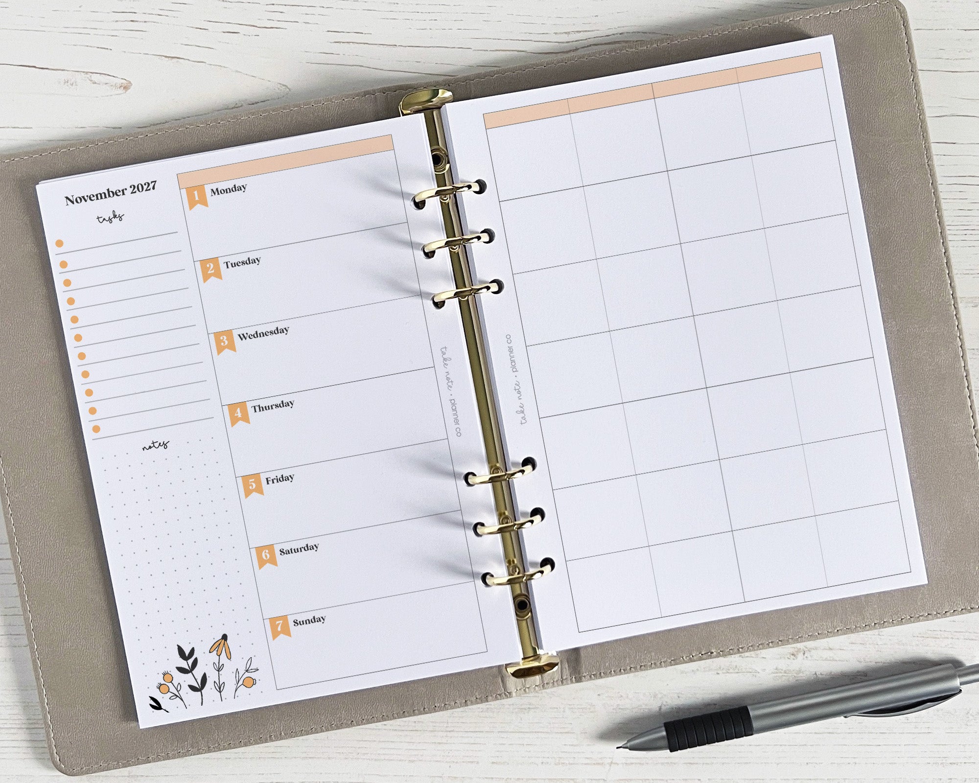A5 weekly planner inserts with a floral design, featuring space for personal and work plans, or other information. The planner is open, displaying the weekly spread, and a pen is lying next to it.