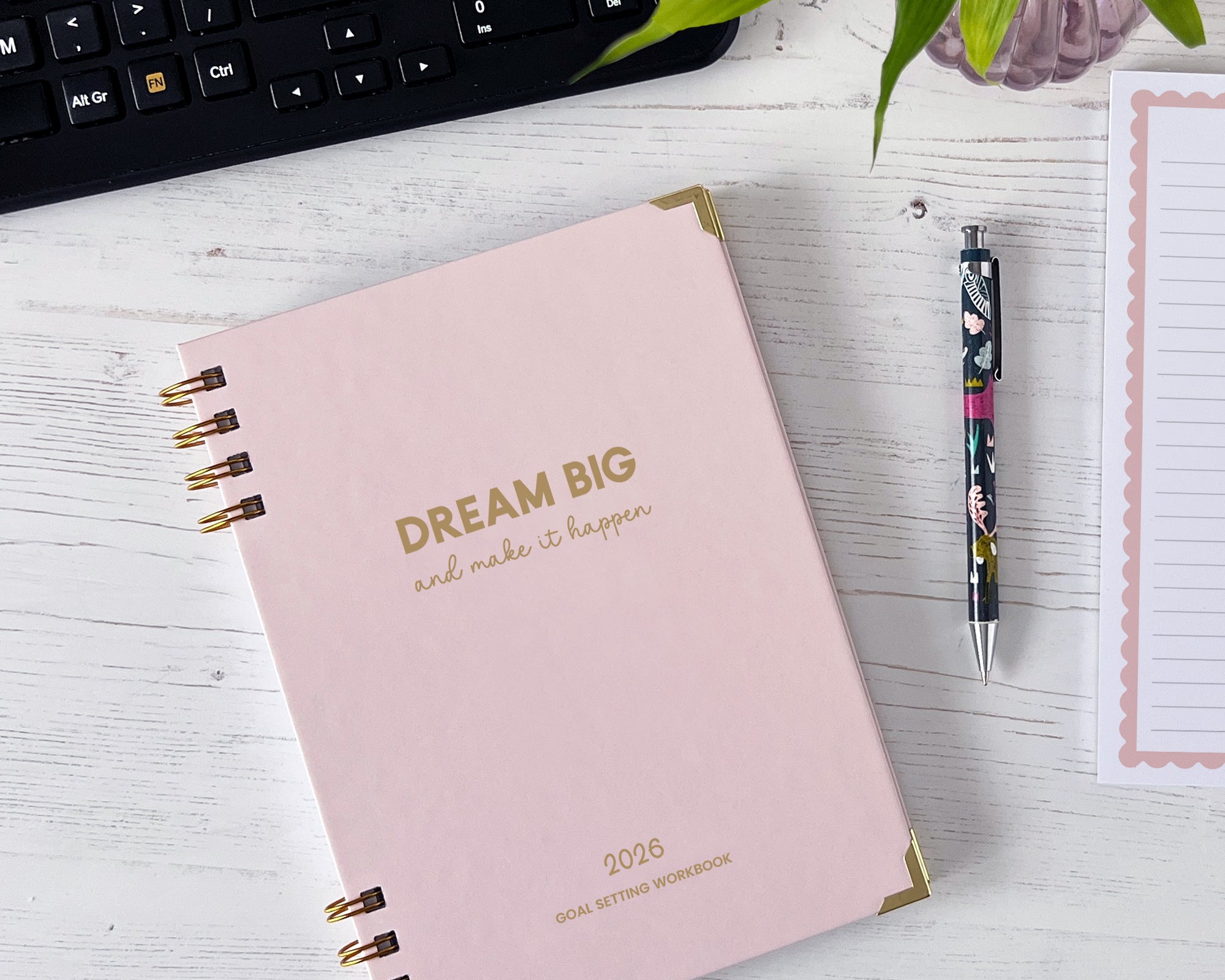 2026 goal setting workbook with 'Dream Big and Make it Happen' text on a white surface with a keyboard and pen.