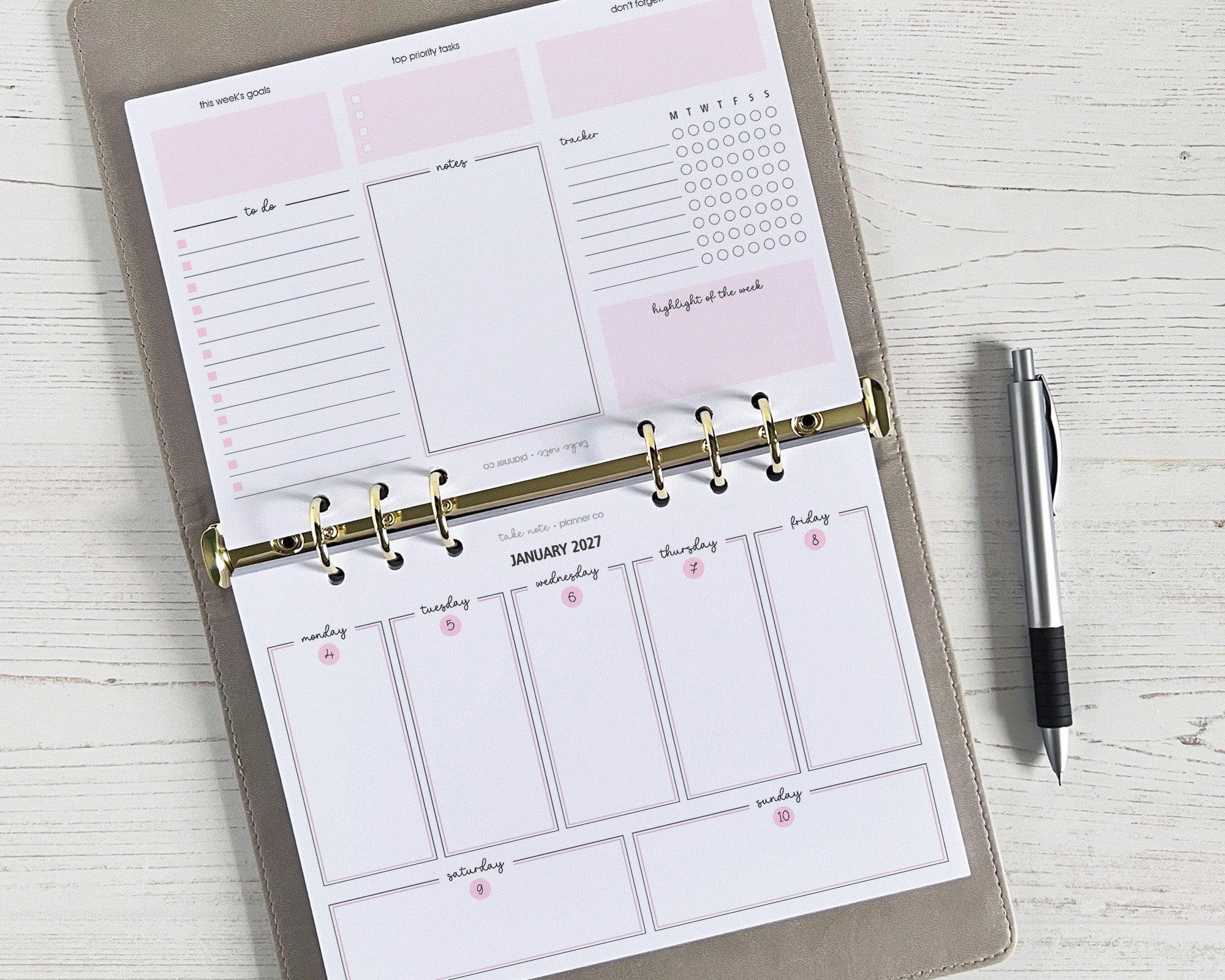 A5 weekly planner inserts with a landscape layout displayed on a desk, featuring space for notes, schedule, and a to-do list with a pen alongside.