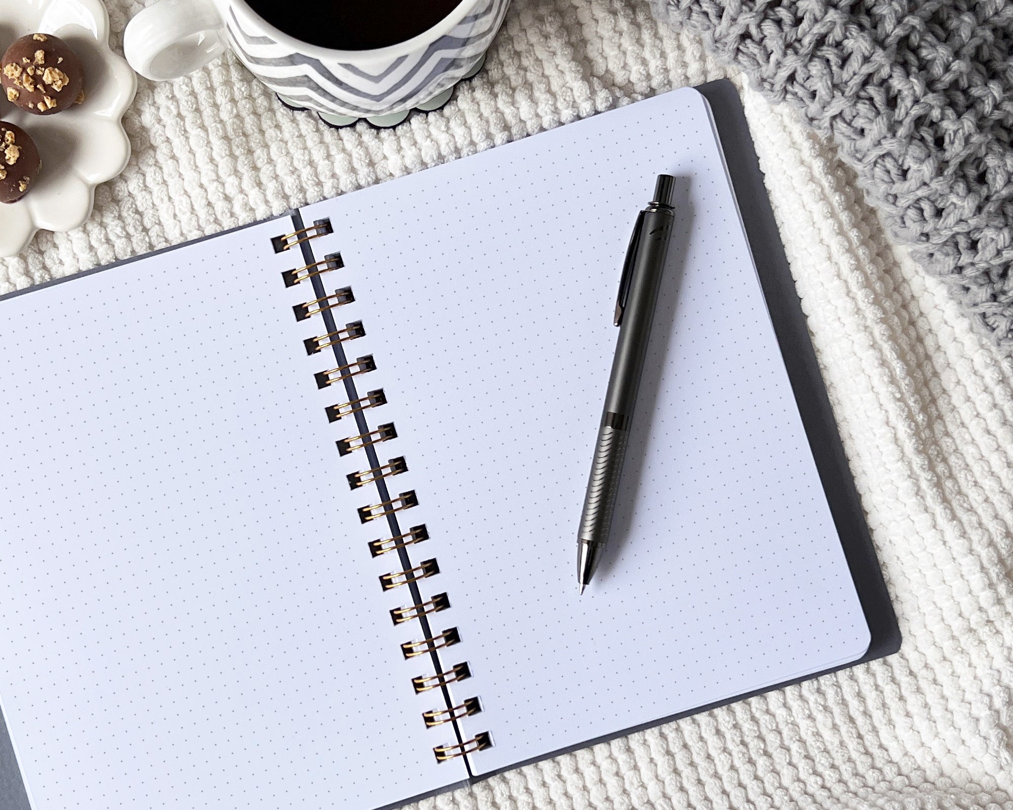 Open journal with a pen on a blanket