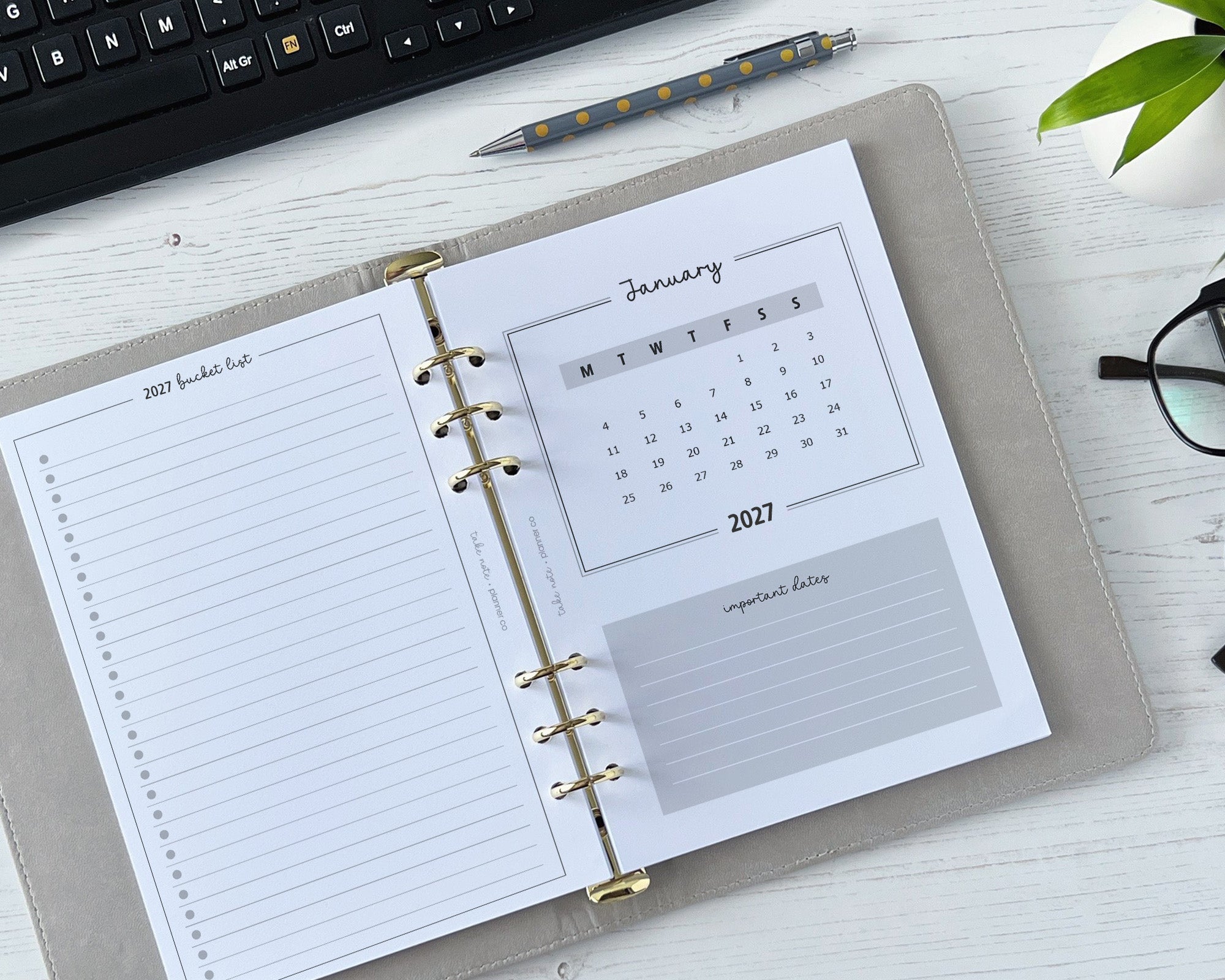 Open planner with calendar and notes on a desk