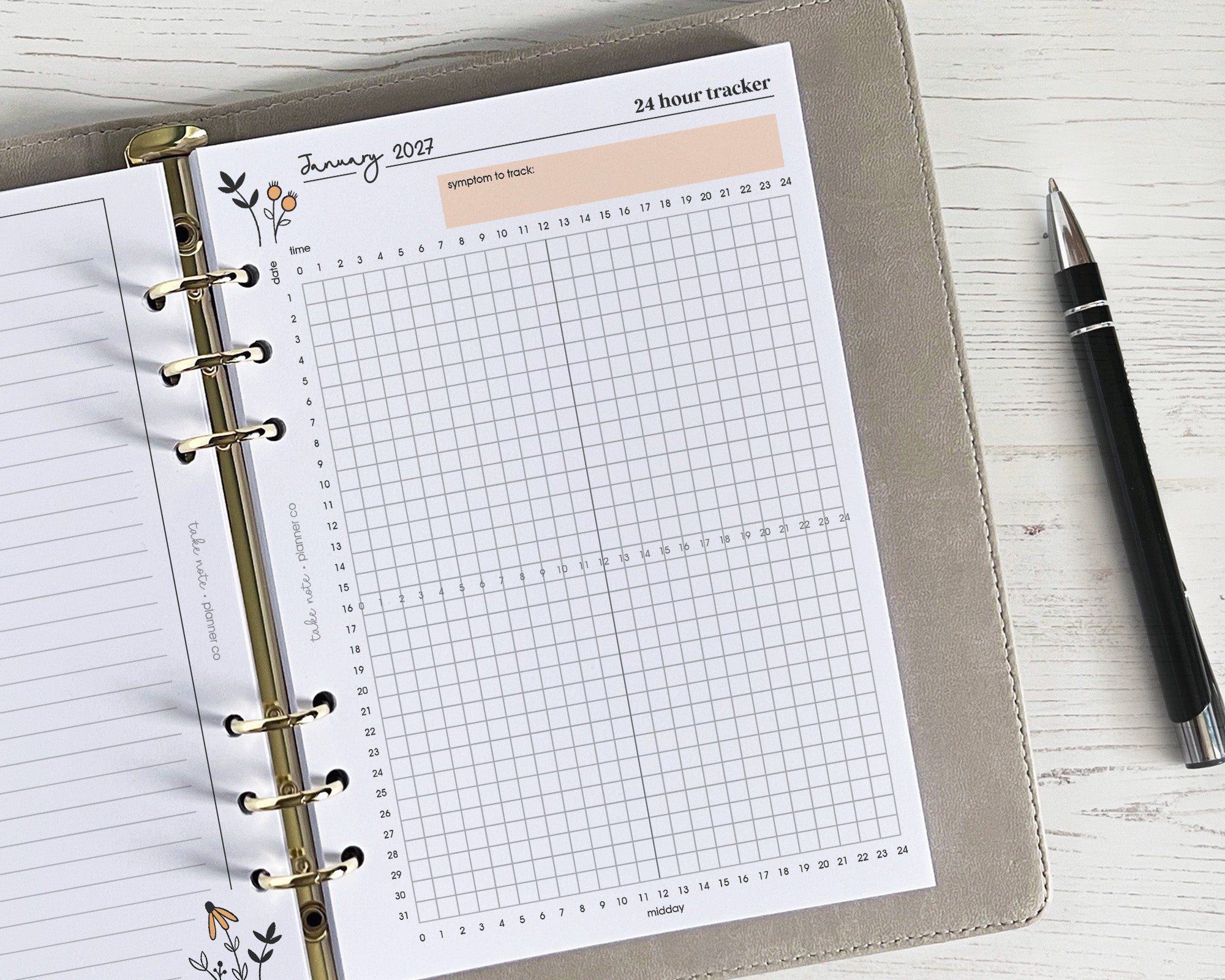 Symptom planner page with grid design and pen on a wooden surface