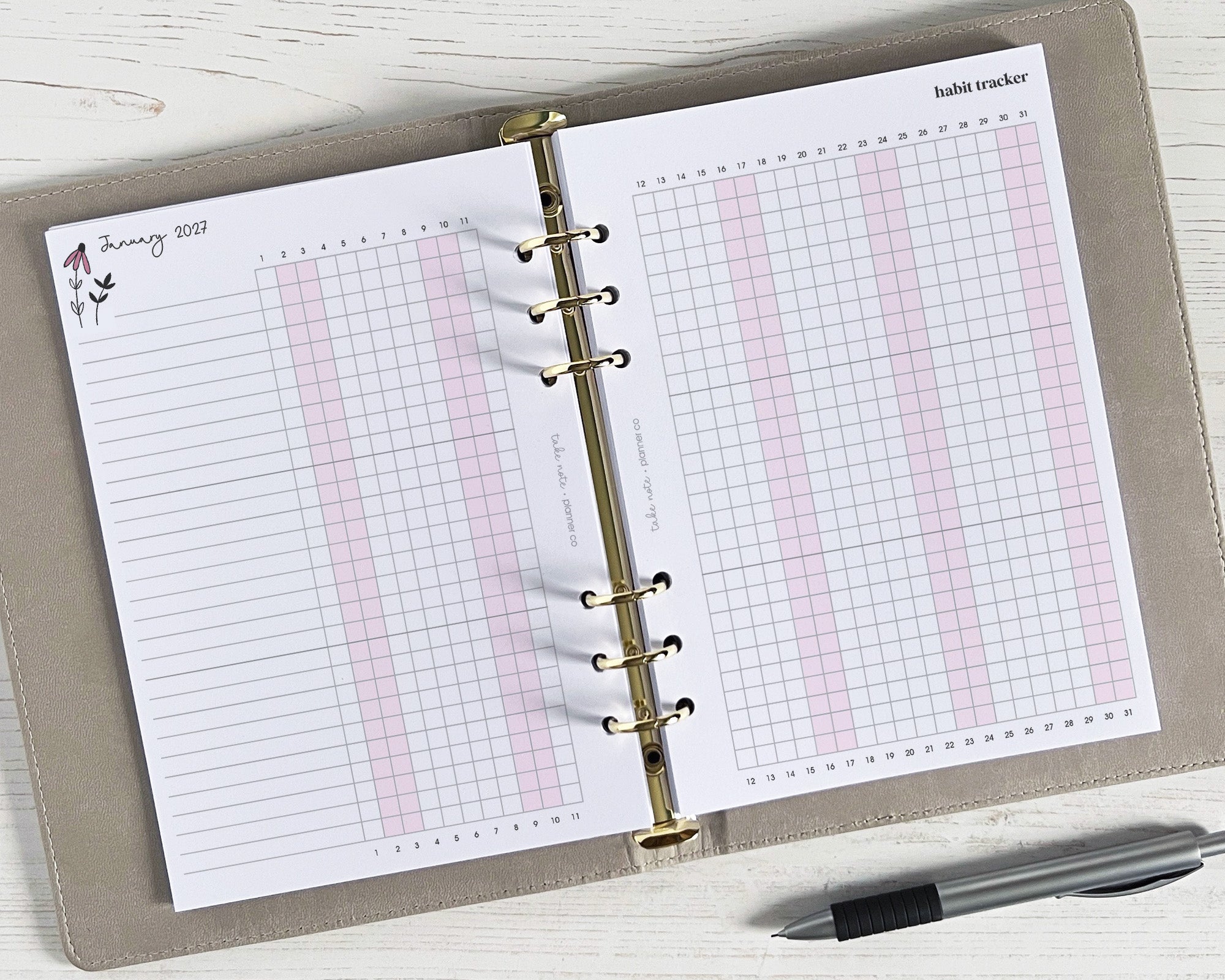 Open planner with habit tracker page on a wooden surface