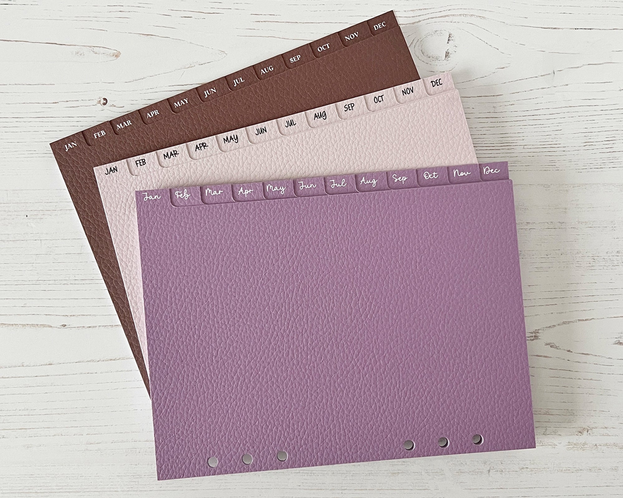 Monthly dividers shown in cocoa, soft taupe and lavender with different fonts